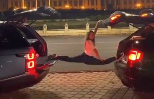 VIDEO Șpagatul perfect pe două mașini de lux! Gimnasta Asiana Peng a făcut senzație în Piața Constituției