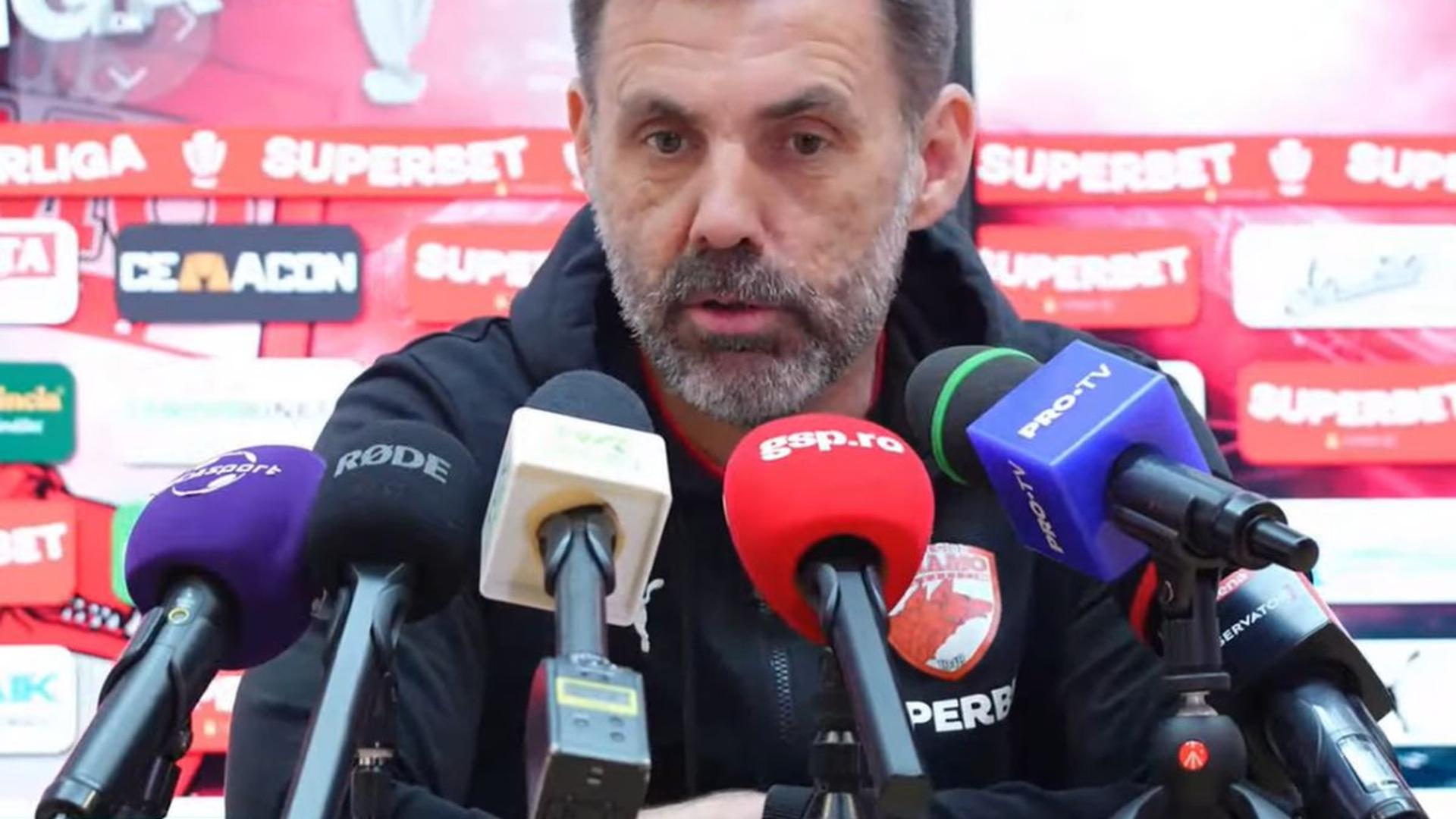 Antrenorul Zeljko Kopic vorbind la conferința de presă înaintea meciului U Cluj vs Dinamo din Superliga, cu logo-urile echipelor vizibile | sursa foto: Gazeta Sporturilor