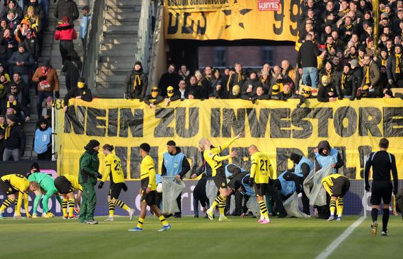 Meci din Bundesliga, întrerupt dintr-un motiv neobișnuit » Un jucător al lui Dortmund, lovit în cap de propriii fani! + Pentru ce protestau suporterii